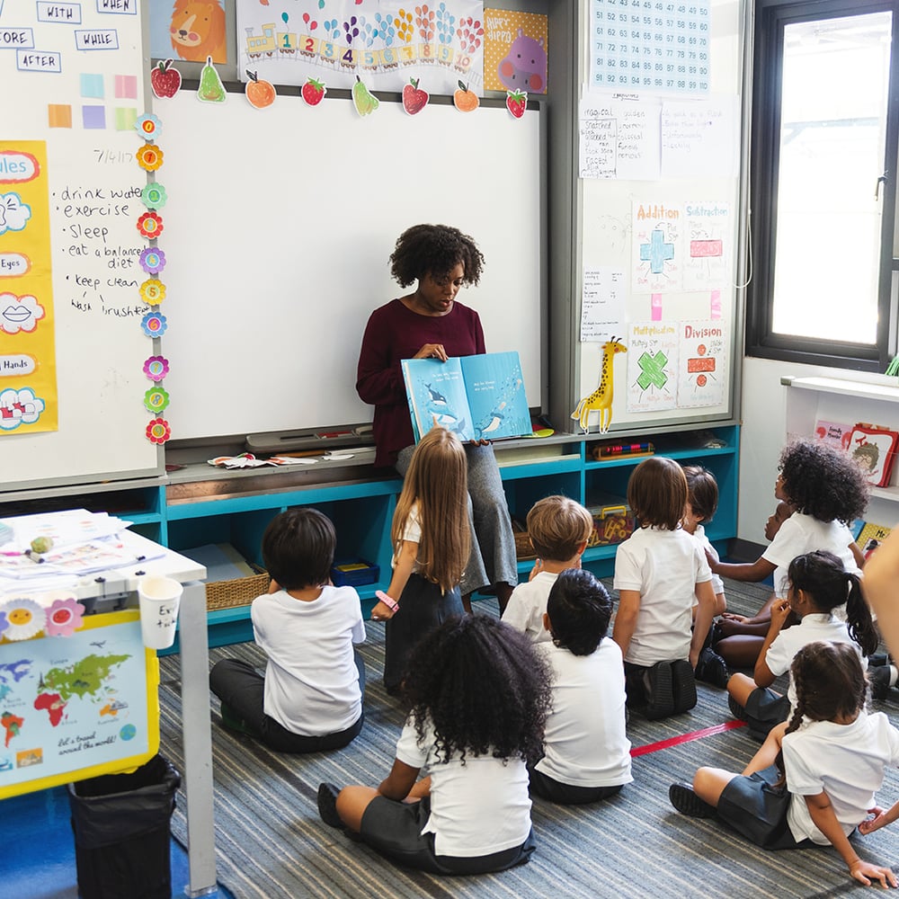 teacher-reading-book-to-class
