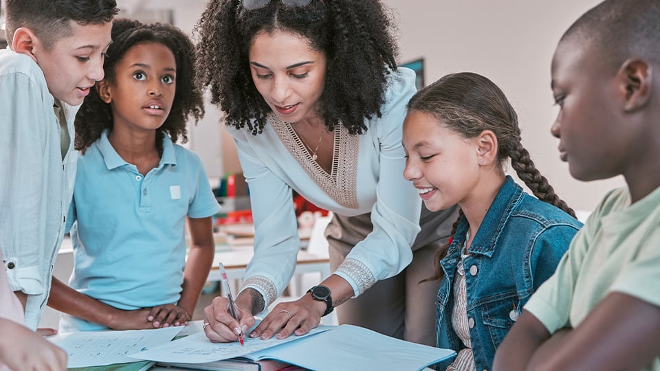 teacher-writing-note-in-students-notebook